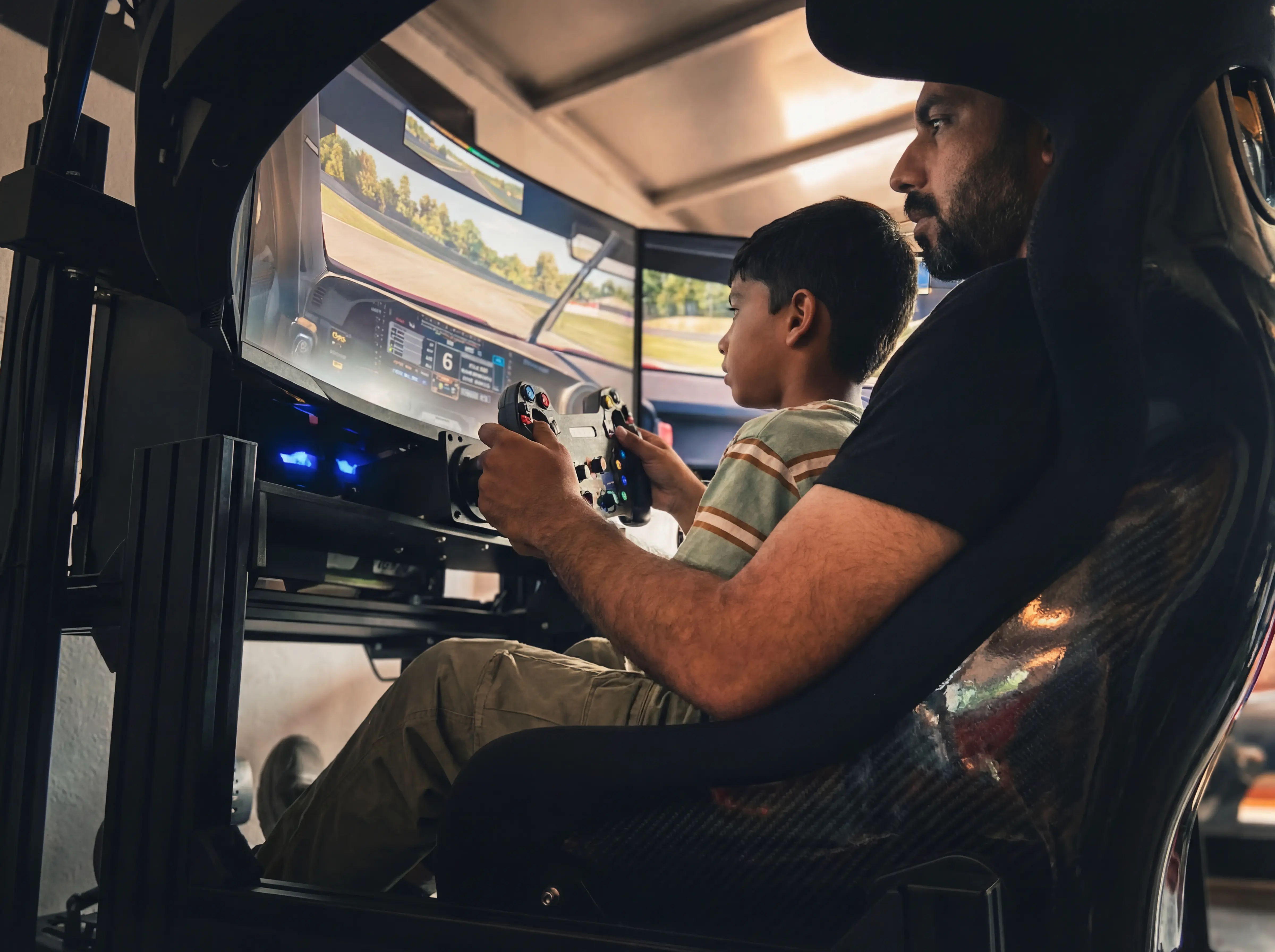 Father and son engaging with the Race To Approval simulator